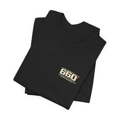 Folded black Violent by Design tee showing the official cream-and-red chest mark