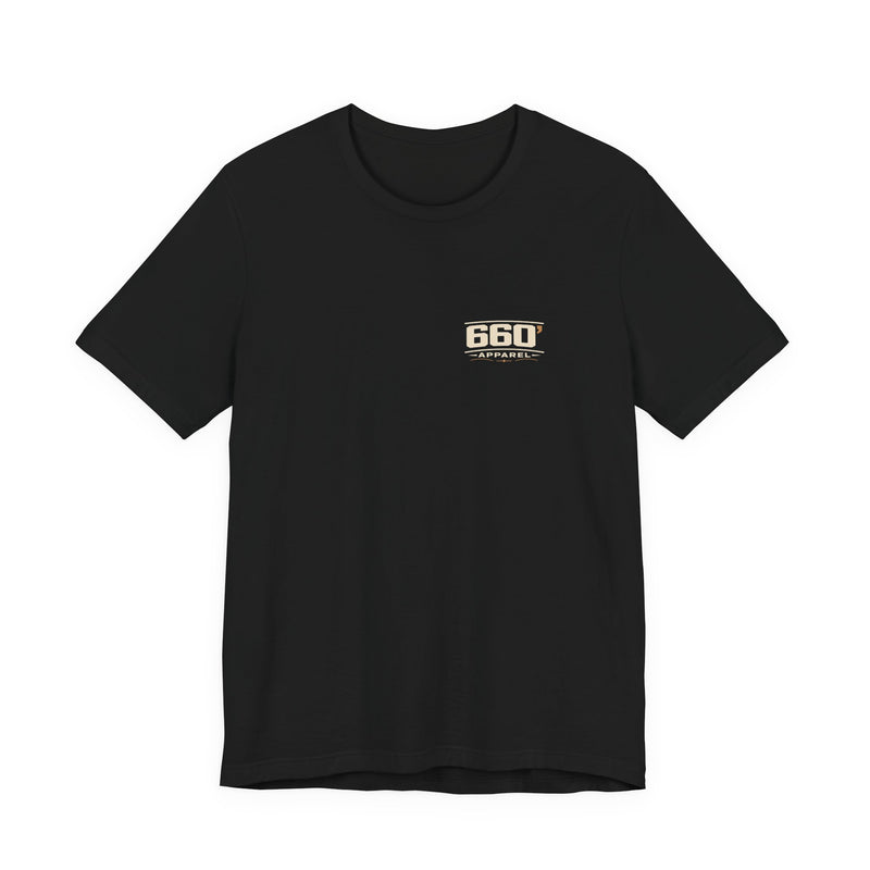 Front of black Bella+Canvas 3001 tee with small master-derived 660′ Apparel western logo on the left chest