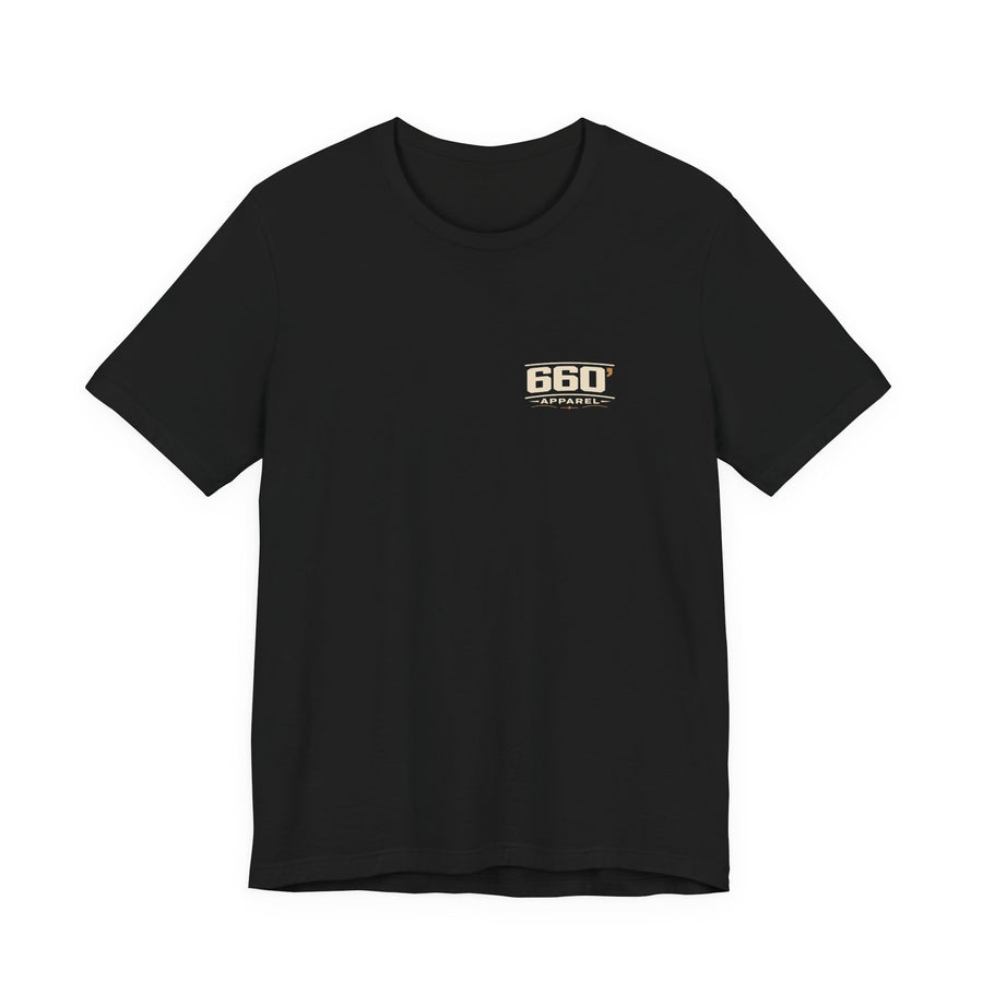 Front of black Bella+Canvas 3001 tee with small master-derived 660′ Apparel western logo on the left chest
