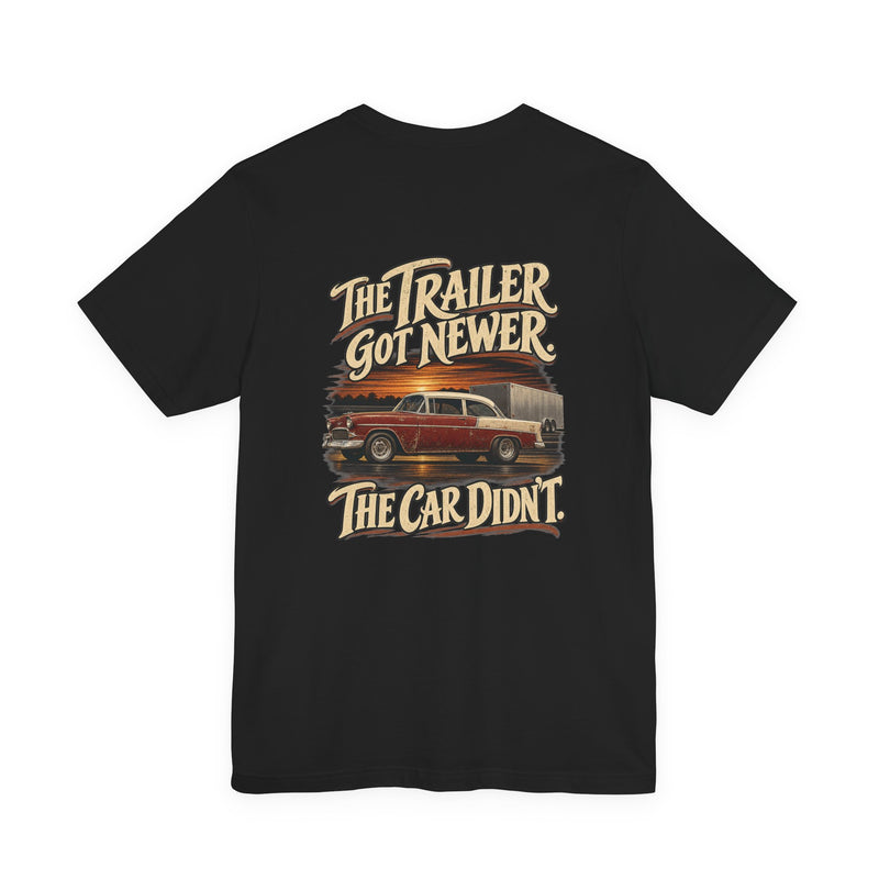 The Trailer Got Newer. The Car Didn't. — Old School Tee — back graphic on black Bella+Canvas 3001